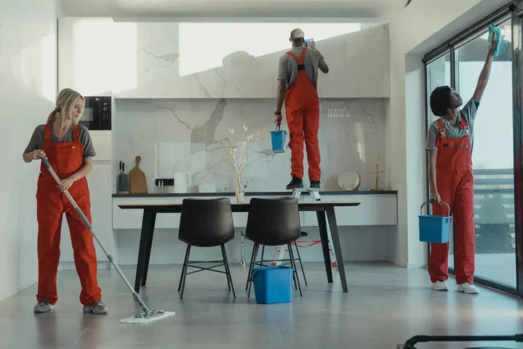 Person mopping an open-plan living area during weekly cleaning in Harrisburg, NC.